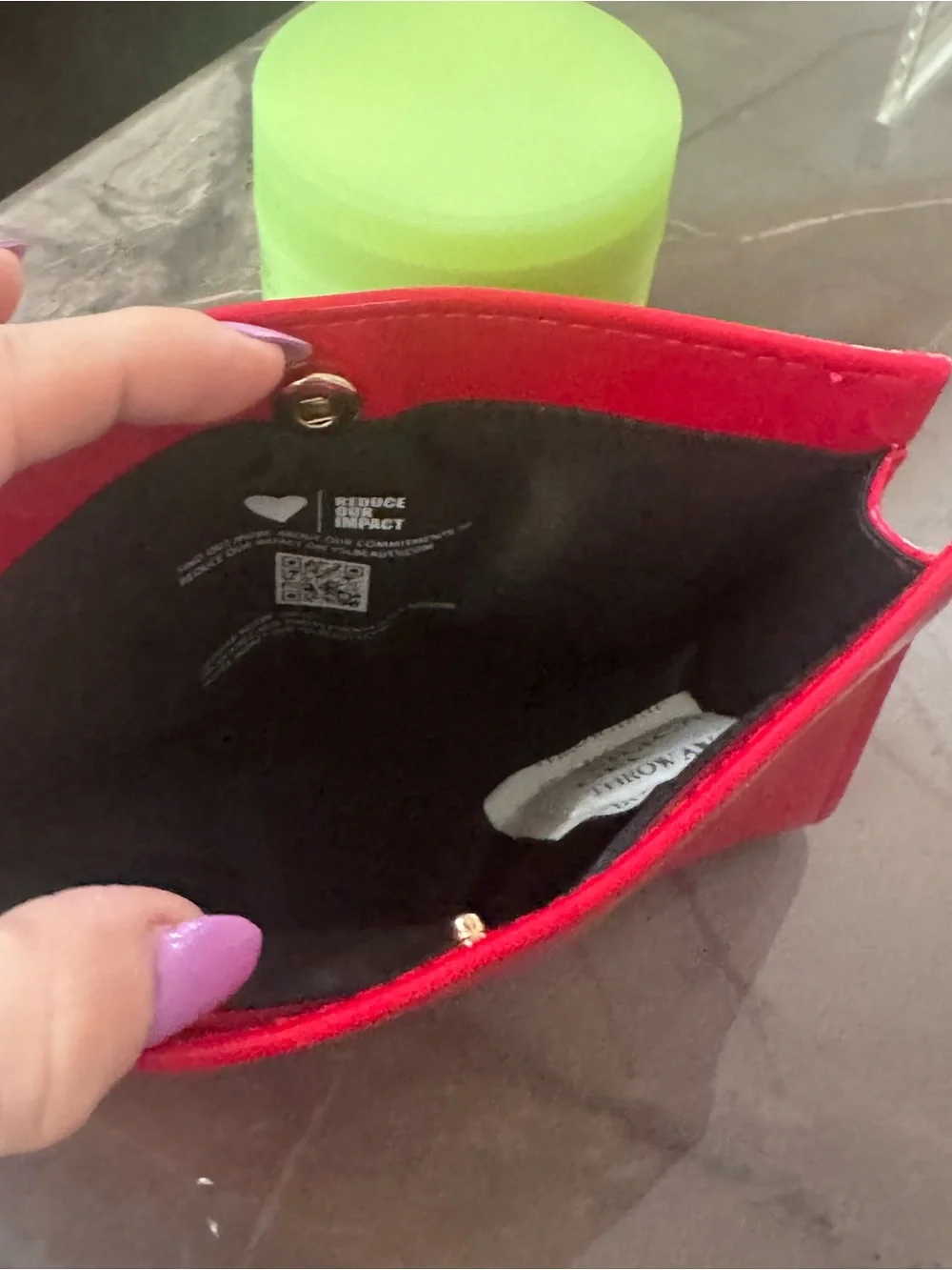 This is a bright red patent PVC Yves Saint Laurent Beauté cosmetic bag featuring